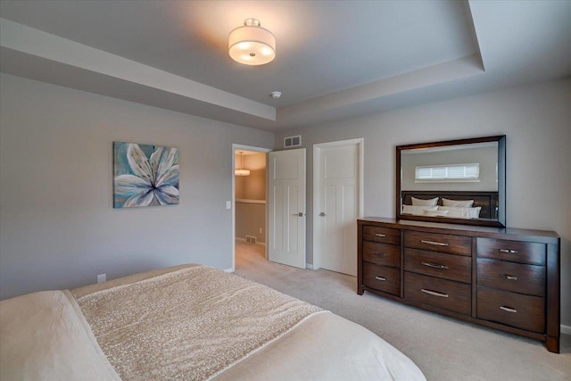 9327 Silicon Prairie Pkwy, Verona, WI 53593 - bedroom with light carpet, a raised ceiling, and baseboards