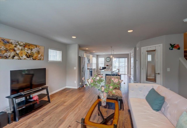 9327 Silicon Prairie Pkwy, Verona, WI 53593 - living area with baseboards, light wood finished floors, and recessed lighting