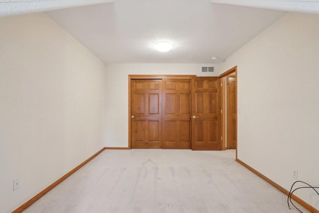 1408 Groves Ln Unit 12, Union Grove, WI 53182 - unfurnished bedroom featuring baseboards and light carpet