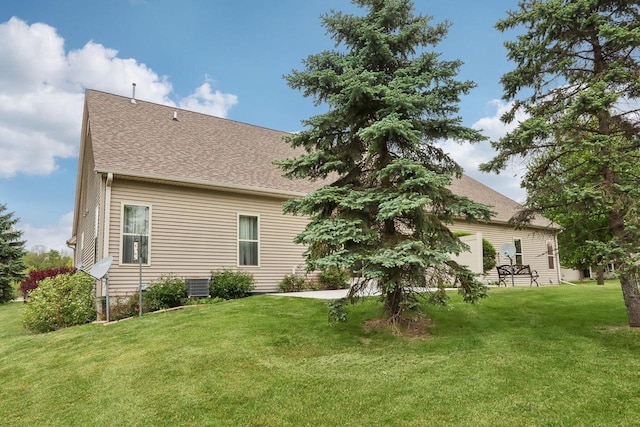 1408 Groves Ln Unit 12, Union Grove, WI 53182 - back of house featuring a yard and a shingled roof