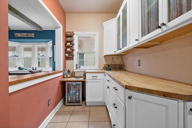 2207 N 51st St, Milwaukee, WI 53208 - bar area with wine cooler, light tile patterned floors, and baseboards