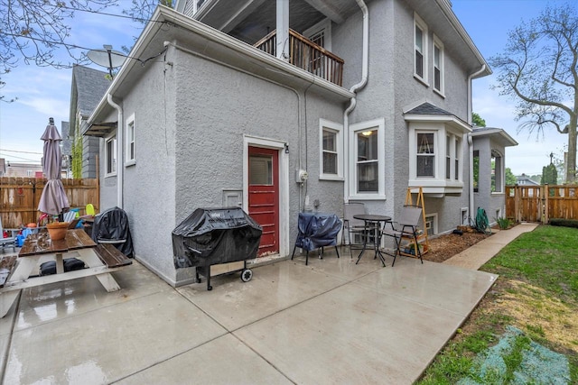 2207 N 51st St, Milwaukee, WI 53208 - rear view of property featuring a balcony, a patio, and stucco siding