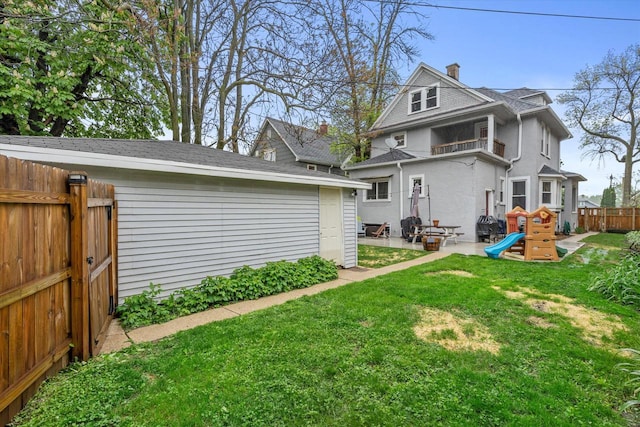 2207 N 51st St, Milwaukee, WI 53208 - back of house with a patio, a chimney, and a balcony