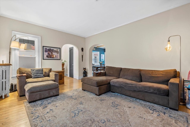 2207 N 51st St, Milwaukee, WI 53208 - living room with arched walkways, wood finished floors, and crown molding