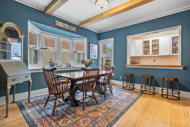 2207 N 51st St, Milwaukee, WI 53208 - dining space with beamed ceiling, hardwood / wood-style floors, baseboards, and crown molding