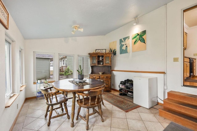3609 Brigham Ave, Madison, WI 53714 - dining space featuring light tile patterned floors, stairway, and baseboards