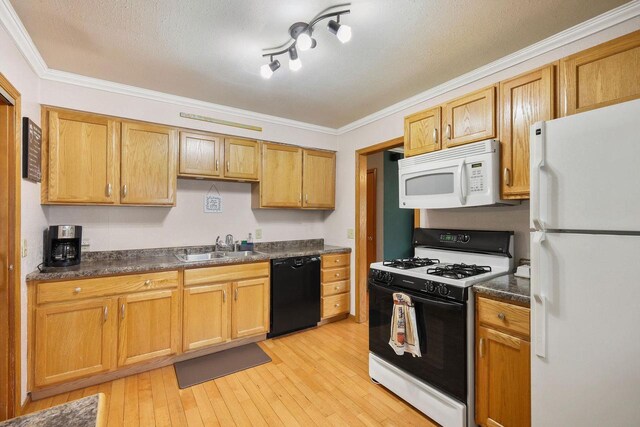 3609 Brigham Ave, Madison, WI 53714 - kitchen with white appliances, ornamental molding, dark countertops, a sink, and light wood-style flooring