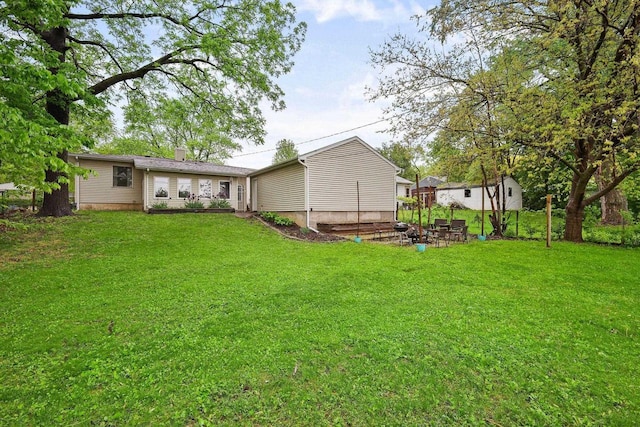 3609 Brigham Ave, Madison, WI 53714 - rear view of property with a yard and a chimney