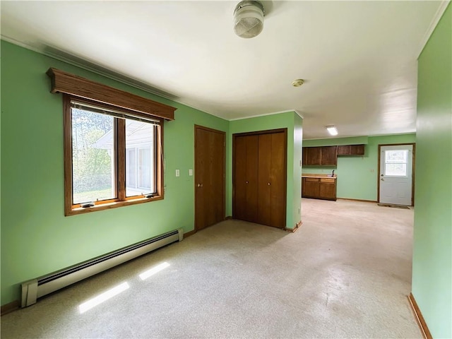 N4719 Schmidt Rd, Ladysmith, WI 54848 - unfurnished living room featuring a baseboard radiator, light colored carpet, and baseboards
