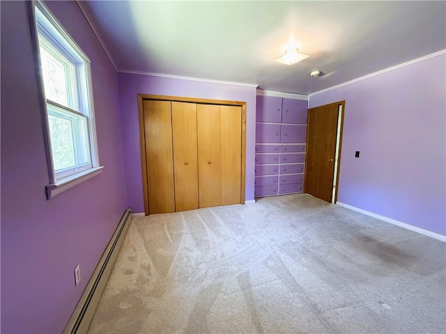 N4719 Schmidt Rd, Ladysmith, WI 54848 - unfurnished bedroom featuring light carpet, a baseboard heating unit, a closet, crown molding, and baseboards