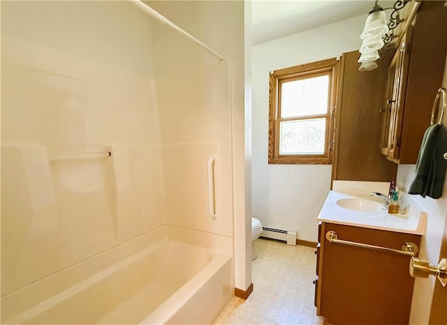 N4719 Schmidt Rd, Ladysmith, WI 54848 - full bathroom featuring baseboard heating, tile patterned floors, toilet, vanity, and tub / shower combination