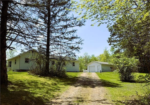 N4719 Schmidt Rd, Ladysmith, WI 54848 - view of front facade featuring driveway, an outbuilding, a garage, and a front yard
