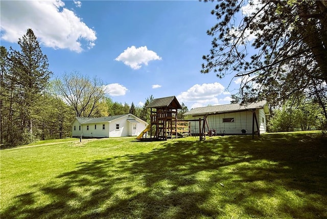 N4719 Schmidt Rd, Ladysmith, WI 54848 - rear view of house featuring a playground and a lawn