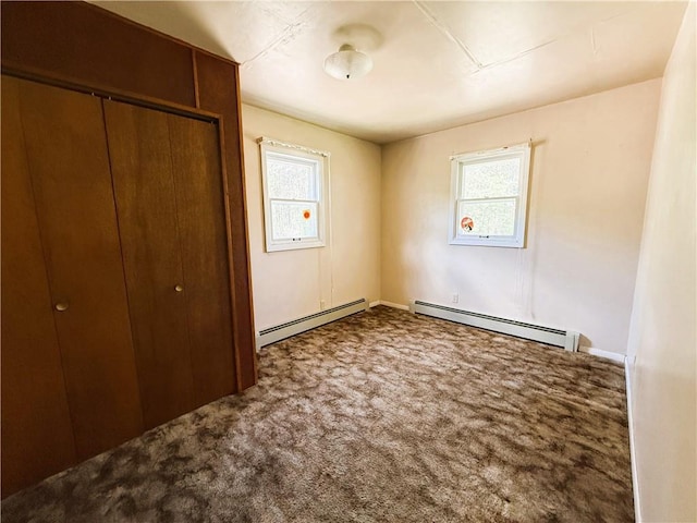 N4719 Schmidt Rd, Ladysmith, WI 54848 - unfurnished bedroom with baseboard heating, multiple windows, and carpet flooring