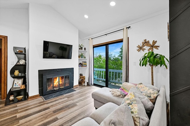 2504 S Delaware Ave Unit 102, Milwaukee, WI 53207 - living room with wood finished floors, a fireplace with flush hearth, vaulted ceiling, recessed lighting, and built in shelves