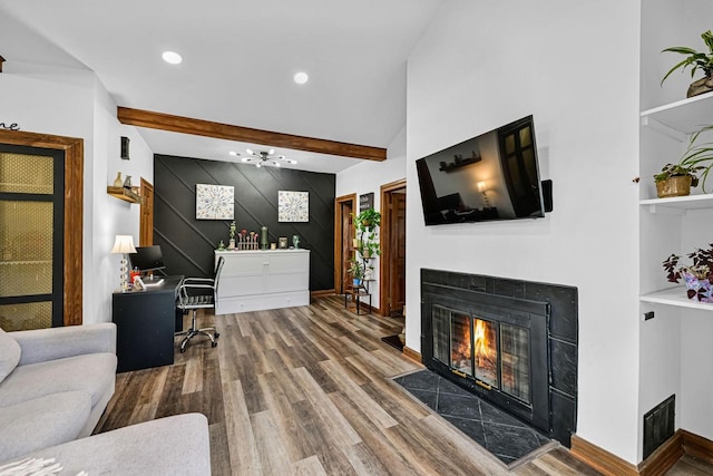 2504 S Delaware Ave Unit 102, Milwaukee, WI 53207 - living area featuring a fireplace with flush hearth, wood finished floors, beamed ceiling, a desk, and recessed lighting