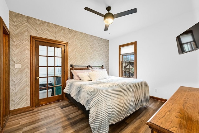 2504 S Delaware Ave Unit 102, Milwaukee, WI 53207 - bedroom featuring wallpapered walls, an accent wall, baseboards, dark wood-style floors, and ceiling fan