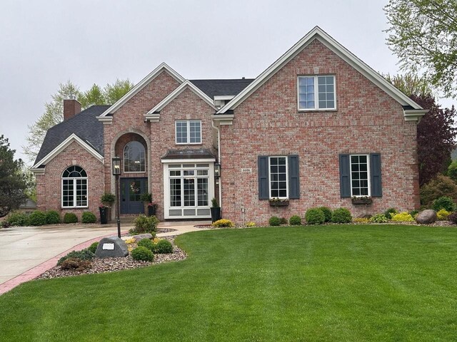 6606 Fieldstone Ct, Racine, WI 53402 - view of front facade featuring a chimney, brick siding, and a front yard