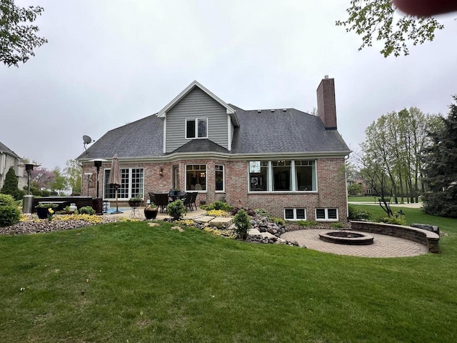 6606 Fieldstone Ct, Racine, WI 53402 - rear view of property featuring a patio area, a fire pit, brick siding, a lawn, and a chimney