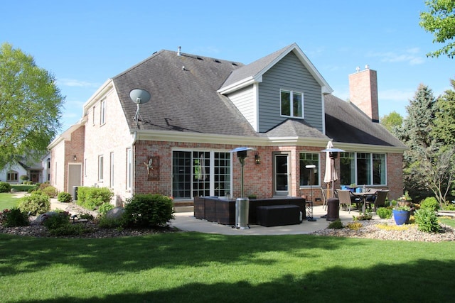 6606 Fieldstone Ct, Racine, WI 53402 - rear view of property featuring a patio, a chimney, brick siding, and a yard