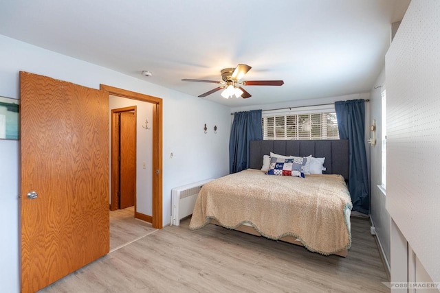 2894 Waubesa Ave, Madison, WI 53711 - bedroom featuring radiator heating unit, wood finished floors, ceiling fan, and baseboards