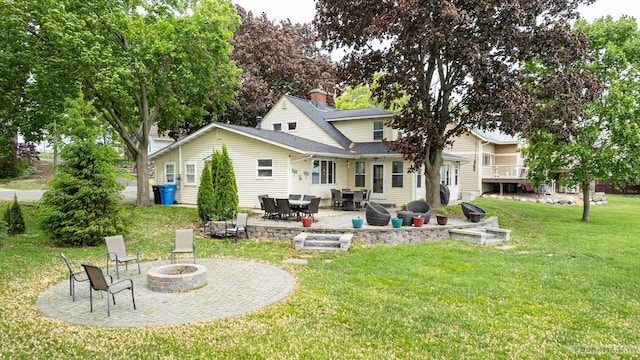 2894 Waubesa Ave, Madison, WI 53711 - back of property with a fire pit, a lawn, and a patio area