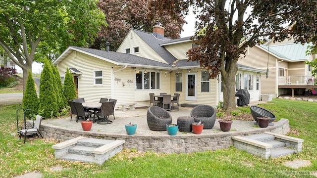 2894 Waubesa Ave, Madison, WI 53711 - back of property with a shingled roof, a patio, a yard, and a chimney
