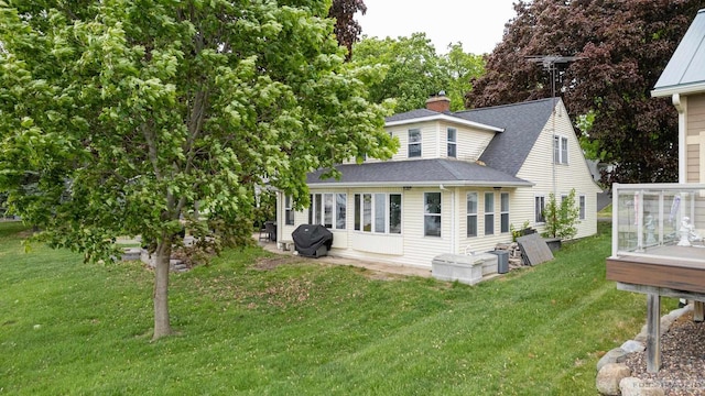 2894 Waubesa Ave, Madison, WI 53711 - back of house featuring a yard, a shingled roof, a chimney, and a wooden deck