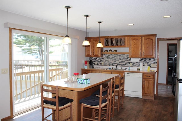 421 River St, Merrimac, WI 53561 - kitchen featuring dishwasher, light countertops, backsplash, brown cabinets, and recessed lighting