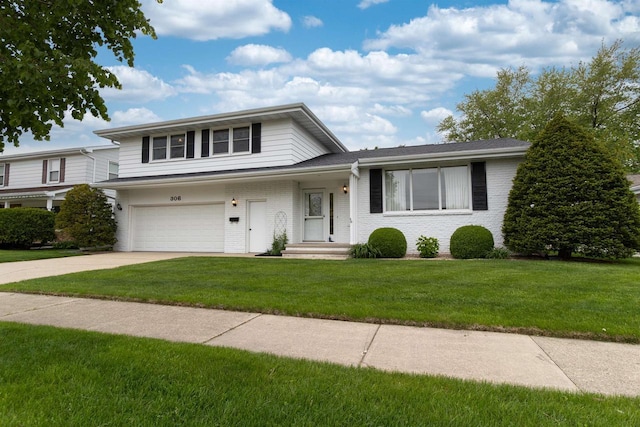 306 W Michigan St, Appleton, WI 54911 - view of front facade with an attached garage, driveway, a front lawn, and brick siding