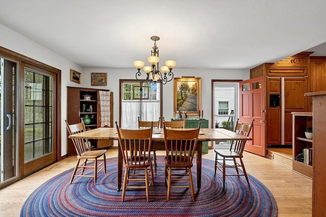 2522 Martha Ave, Green Bay, WI 54301 - dining room with a chandelier, healthy amount of natural light, and light wood finished floors