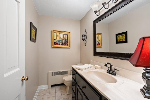 2522 Martha Ave, Green Bay, WI 54301 - half bathroom with radiator, toilet, baseboards, and vanity