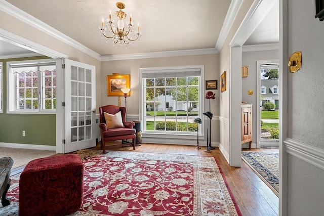 2522 Martha Ave, Green Bay, WI 54301 - living area featuring light wood-type flooring, a chandelier, ornamental molding, and baseboards