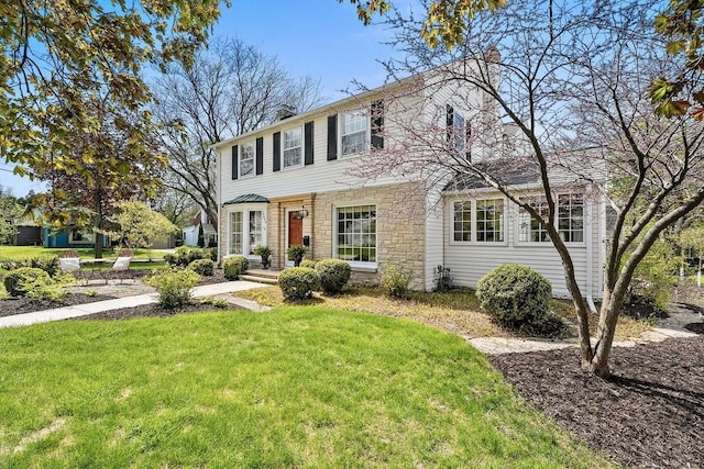 2522 Martha Ave, Green Bay, WI 54301 - view of front facade featuring stone siding, a front lawn, and a chimney