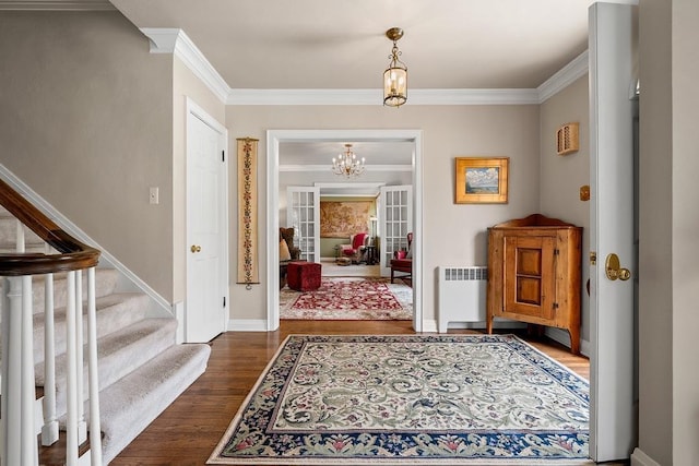 2522 Martha Ave, Green Bay, WI 54301 - entryway featuring radiator heating unit, ornamental molding, dark wood-style flooring, a chandelier, and stairs