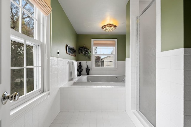 2522 Martha Ave, Green Bay, WI 54301 - full bathroom featuring tile patterned flooring, a garden tub, tile walls, and a wainscoted wall