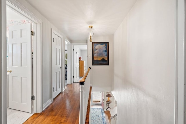 2522 Martha Ave, Green Bay, WI 54301 - hallway featuring an upstairs landing, wood finished floors, and baseboards