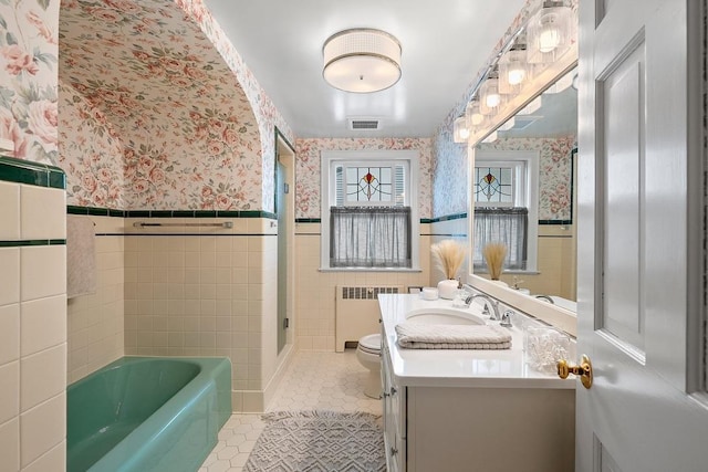 2522 Martha Ave, Green Bay, WI 54301 - bathroom featuring radiator, wallpapered walls, a wainscoted wall, tile patterned floors, and toilet