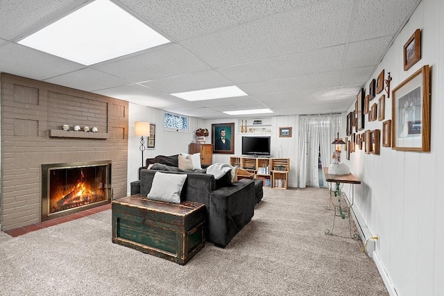 2522 Martha Ave, Green Bay, WI 54301 - carpeted living room with a paneled ceiling, a brick fireplace, and a baseboard radiator