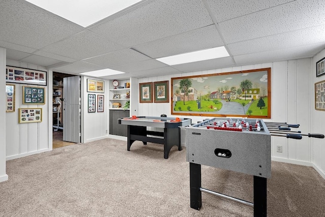 2522 Martha Ave, Green Bay, WI 54301 - rec room featuring carpet, a drop ceiling, built in features, baseboards, and a decorative wall