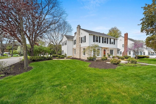 2522 Martha Ave, Green Bay, WI 54301 - view of front facade featuring a chimney, a front lawn, and stone siding