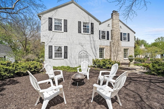 2522 Martha Ave, Green Bay, WI 54301 - back of house featuring a chimney and an outdoor fire pit