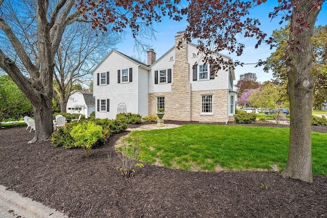 2522 Martha Ave, Green Bay, WI 54301 - view of front of property with stone siding, a chimney, and a front lawn