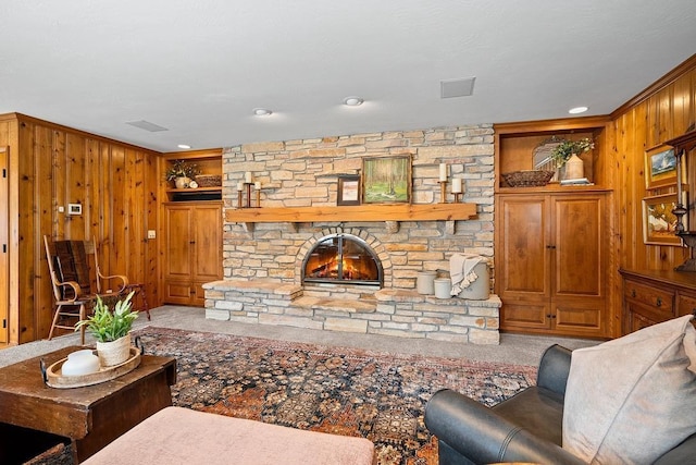 2522 Martha Ave, Green Bay, WI 54301 - living area with wood walls, built in features, carpet, crown molding, and a stone fireplace