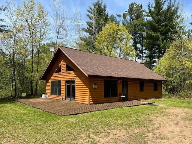 7431 Jordan Buck Trl, Danbury, WI 54830 - back of property featuring a lawn, a deck, faux log siding, and a shingled roof