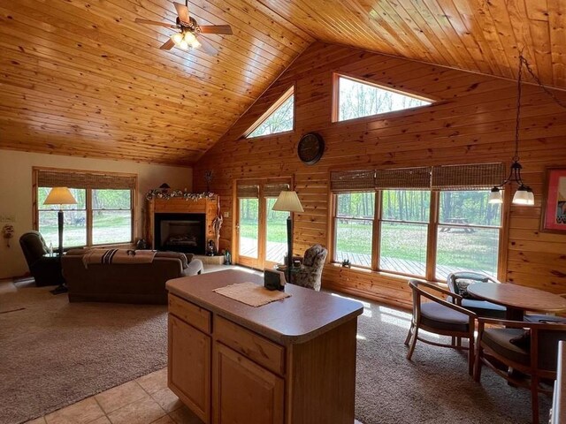 7431 Jordan Buck Trl, Danbury, WI 54830 - living area with wood walls, wood ceiling, light colored carpet, high vaulted ceiling, and ceiling fan