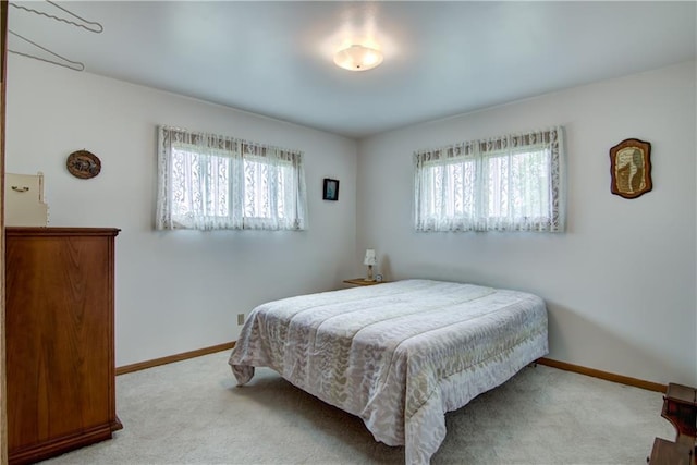 12482 65th Ave, Chippewa Falls, WI 54729 - bedroom featuring multiple windows, carpet flooring, and baseboards