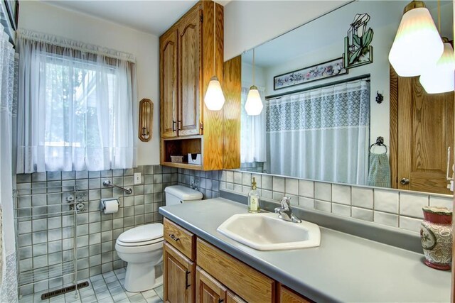 12482 65th Ave, Chippewa Falls, WI 54729 - full bath featuring toilet, tile patterned floors, tile walls, vanity, and a shower with shower curtain