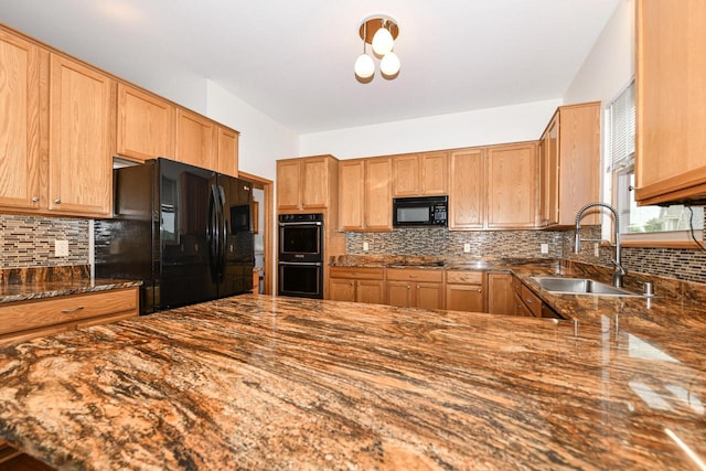 884 Joshua Ct, Pewaukee, WI 53072 - kitchen featuring black appliances, backsplash, a sink, and dark stone countertops