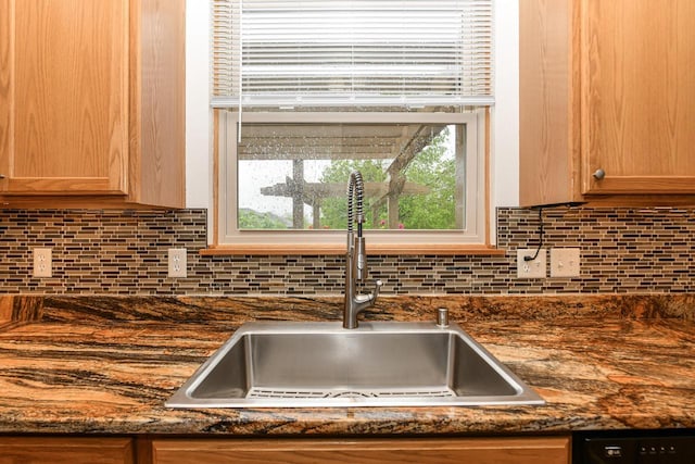 884 Joshua Ct, Pewaukee, WI 53072 - kitchen view of a sink, tasteful backsplash, black dishwasher, and dark stone countertops